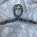 Macro detail of large ink pattern hair claw clip with golden spring and acrylic texture - Transparent Shark Black Dot
