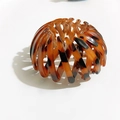 Expandable bird nest hair clip featuring a vintage amber tortoise shell texture finish - Caramel color
