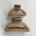 Close-up of matte khaki hair claws in two sizes with crescent curve and secure grip teeth - Small Half-round / Khaki