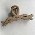 Macro shot of large matte beige hair claw clip with twisted woven design and metal spring - Twisted Chain / Khaki