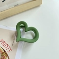 Matte dark green heart-shaped claw clip for hair in a minimalist artistic setting - Green