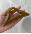 Detail of translucent olive green triangle hair claw clip with gold metal spring - Mustard Yellow