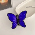 Deep blue translucent butterfly hair claw clip with black edges in a flat lay view - Dark Blue