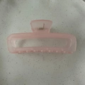 Detail view of large translucent pink rectangular hair claw clip with metal spring - Jelly Pink