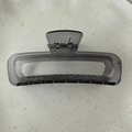 Detail view of large rectangular hollow hair claw clip in transparent smoky grey finish - Transparent Grey Blue