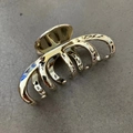 Detail of a shiny gold plated geometric hair claw clip on a grey stone texture background - 4+5 Claw (13cm) / Gold