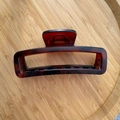 Detailed view of a 12cm amber tortoiseshell hair claw clip with strong metal spring - Matte Red Coffee Tortoise