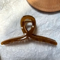 Detail view of amber translucent hair claw clip with glossy finish and sturdy metal spring - Jelly Coffee