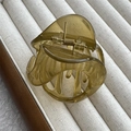 Detail of translucent olive green pumpkin claw clip with golden spring in a display box - Jelly Green