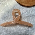 Close-up of a large peach marble hair claw clip with a strong golden metal spring - Jelly Light Orange