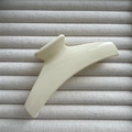 Detail view of the sleek cream-colored glossy finish hair claw clip with its curved design - Bright White