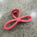 Detailed view of pink hollowed-out hair claw clip showing durable metal spring mechanism - Rose Red