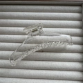 Detail of transparent acrylic hair claw clip with metal spring on a grey textile tray - Clear