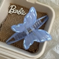 Detail of light blue butterfly claw clip with elegant ribbon weave and icy texture finish - Blue