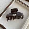 Detail of a brown translucent claw clip with gold Barrette La France lettering - Dark Tea Gray Rectangular Hollow Claw (Style A)