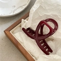 Glossy deep red resin hair claw clip displayed on a minimalist wooden tray with paper - Small Cross Style Ankara Red