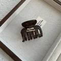 Detail view of tortoiseshell resin hair claw clip with golden French lettering engraving - Dark Tea Gray Small Claw (Style C)