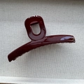 Macro shot of polished burgundy shark hair claw clip on neutral textured fabric - Single Hole Ankara Red / Large