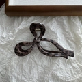Detail view of leopard print hair claw clip with bow design and gold metal spring - Bow / 13cm / Dark Leopard
