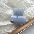 Close-up of light blue hair claw clip with golden handmade metal plate and glossy finish - Geometric Metal Label