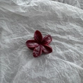 Detailed view of 4cm deep burgundy marble pattern flower hair claw clip on white background - Red