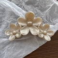 Detail showing the pearlescent finish and three flower shapes on a resin hair claw - Pearlescent Khaki