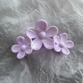 Macro detail of purple marble flower hair claw with three camellia blossoms and smooth finish - Purple
