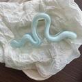 Detail of light green wave hair claw with semi-transparent frosted texture and silver spring - Green