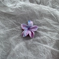 Macro view of purple marble floral hair claw clip with glossy finish on paper - Gradient Purple