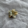 Close-up of a 4cm marble-patterned flower hair claw clip with glossy cream and brown finish - Brown