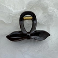 Detail of elegant dark brown bow-shaped hair claw clip with golden metal spring - Red Brown