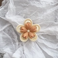 Close-up of matte tulip flower hair claw clip with orange petals on white paper background - Orange