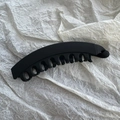 Detailed view of matte black banana hair clip with interlocking teeth for secure grip - Matte Black