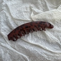 Detail shot of leopard print tortoise shell banana hair clip with curved comb teeth - Red Coffee Leopard