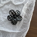 Detail of five-petal flower hair claw clip with black and white checkered pattern inlay - Black Plaid Flower