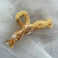 Detailed view of amber acetate hair claw clip with white marble ink texture and gold spring - Twisted Woven Design