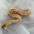 Detail view of marble patterned amber and pearl white S-shaped acetate hair claw clip - Serpentine Shape