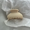 Close-up of a glossy cream PC fan-shaped hair claw clip with smooth resin finish - Solid White