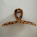 Detail view of large leopard print hair claw clip with strong metal spring and resin texture - 13cm / Crisscross Yellow Coffee Leopard