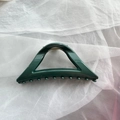 Detail showing deep green triangular hair claw clip with glossy finish on mesh fabric - Dark Green Triangle