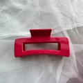 Detailed view of large hot pink matte finish shark hair claw clip for women's hairstyling - Red Block