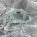 Close-up of light blue translucent hair claw clip with wavy lines and golden spring - Cloud Blue Two-tone Hair Clip