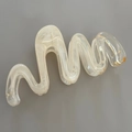 Detail view of large wavy marble hair claw clip with cream jelly patterns and metal spring - 13cm / Champagne Flow Pattern