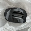 Close-up of minimalist hollow oval hair claw clip with a high-gloss black mirror finish - 10cm Oval Glossy Black