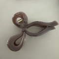 Macro detail of large brown bow hair claw clip made of acetate with metal spring - Milk Tea