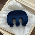 Detailed view of a dark blue flocked shark hair claw clip in a minimalist box setting - Blue Flocked M-Shape