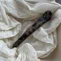 Detail shot of a long leopard tortoiseshell hair clip on minimalist white paper texture - Round Greyish White Clip