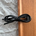 Detail view of the black faux leather bow hair clip with a vintage metal duckbill clamp - Black Leather Bow
