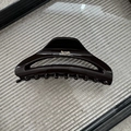 Macro view of glossy large hair claw clip with white Barrette LaFrance text logo - 12cm Large Reddish Brown