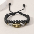Ethnic double-layer braided bracelet with matte black beads and vintage metal charm - Bracelet